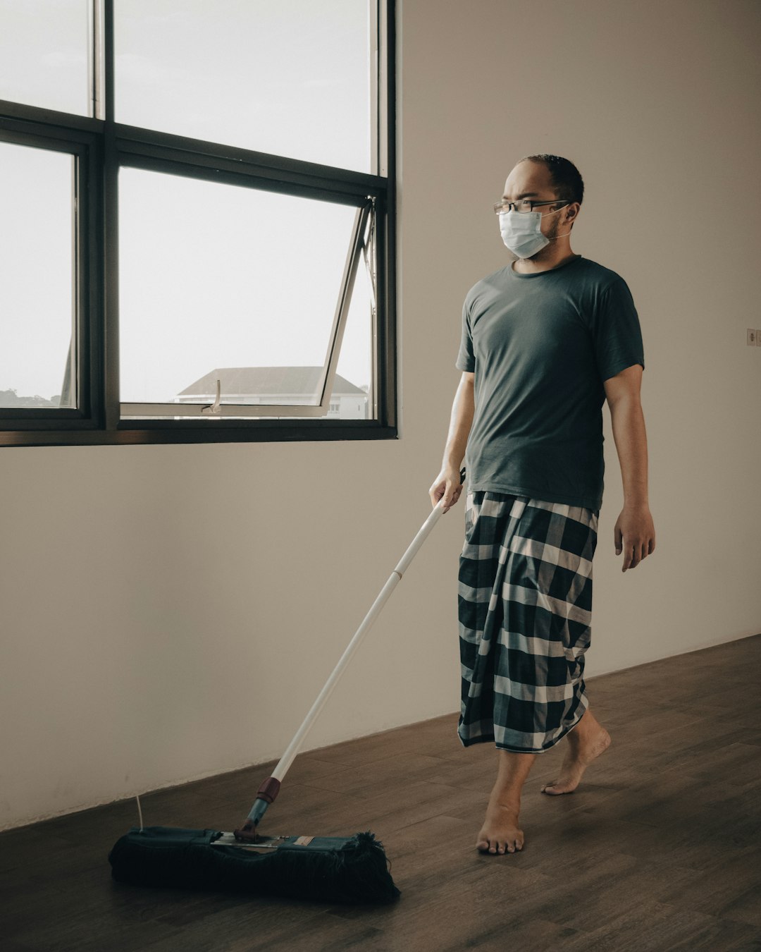 why-choose-us-02 a-man-with-a-face-mask-is-cleaning-the-floor-bhgul2hzin8